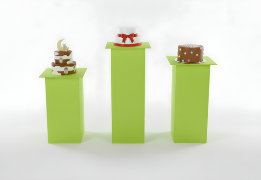 Three small cakes on green stands with a white background