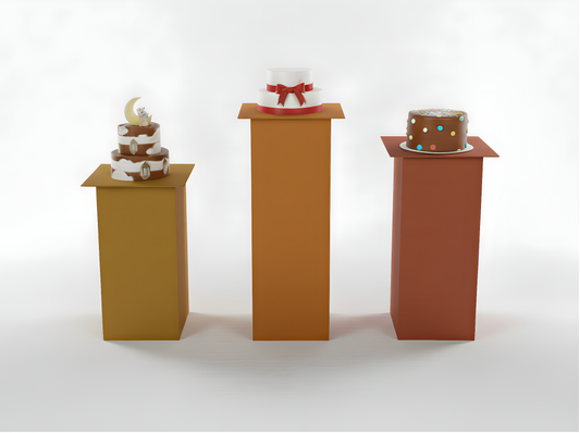 Three small cakes on stands against a white background
